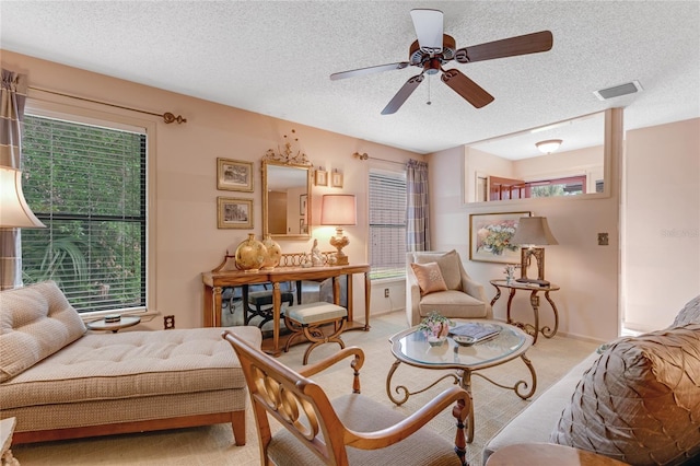 15 Morning Dew Trl, Ormond Beach, FL 32174 - living area featuring a textured ceiling, carpet floors, a ceiling fan, and baseboards