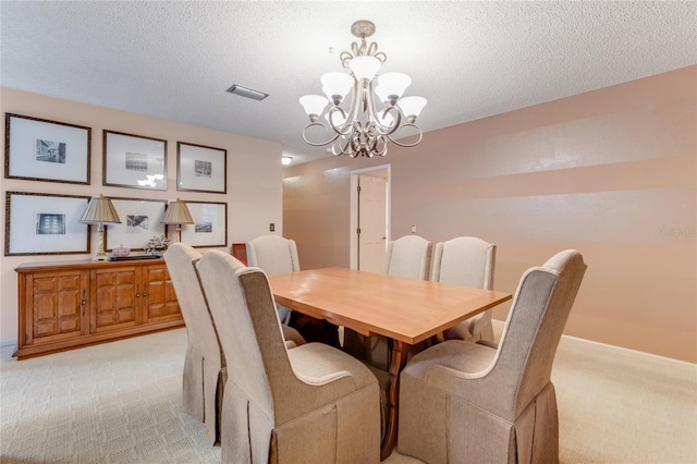 15 Morning Dew Trl, Ormond Beach, FL 32174 - dining space featuring light colored carpet, a chandelier, a textured ceiling, and baseboards
