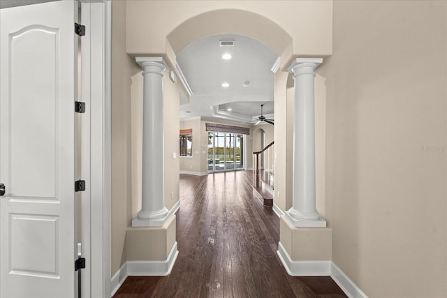 corridor featuring ornate columns, recessed lighting, dark wood finished floors, and baseboards