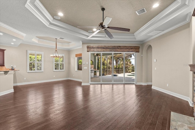 unfurnished living room featuring arched walkways, visible vents, a raised ceiling, and ceiling fan with notable chandelier