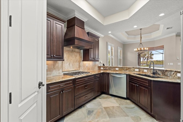 kitchen with a sink, premium range hood, stainless steel appliances, a tray ceiling, and visible vents