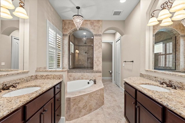 full bath with visible vents, a sink, a bath, and tiled shower