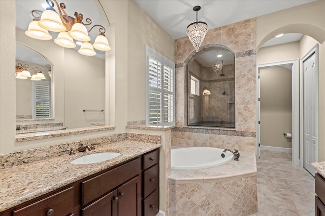full bathroom with vanity, a garden tub, and a tile shower