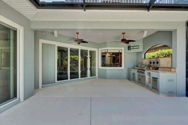 view of patio / terrace with area for grilling, ceiling fan, and a grill