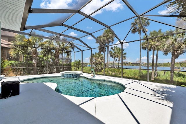 view of pool featuring a patio, a water view, a pool with connected hot tub, and glass enclosure