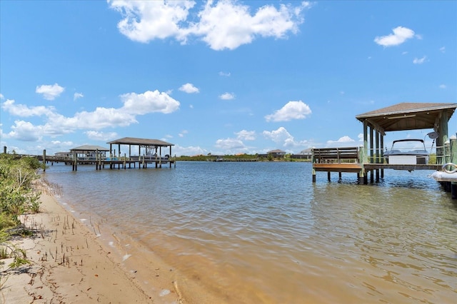 view of dock with boat lift and a water view