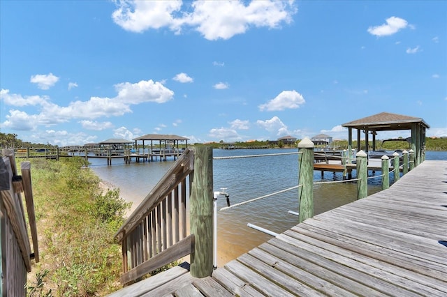 view of dock featuring a water view and a gazebo