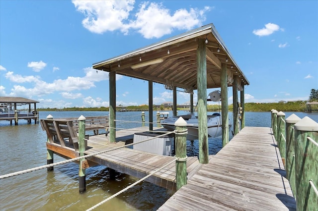 dock area featuring a water view and boat lift