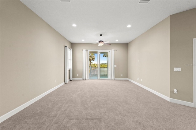 empty room with baseboards, ceiling fan, light carpet, and recessed lighting
