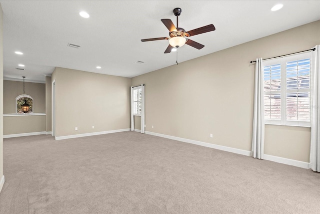 spare room with recessed lighting, baseboards, ceiling fan, and light carpet