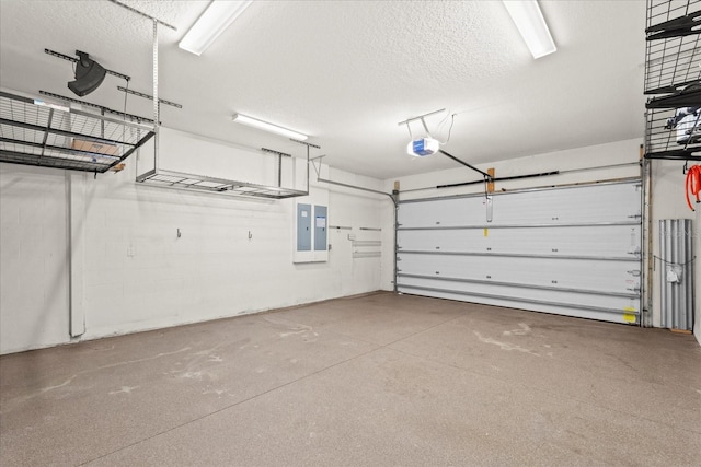 garage with a garage door opener and electric panel