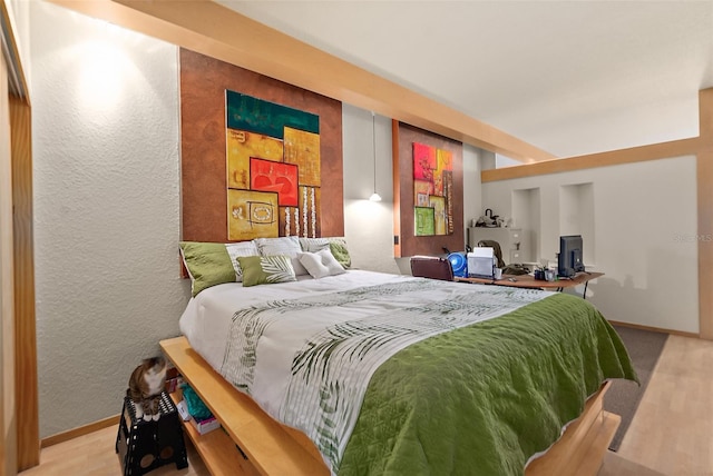 101 Palm Harbor Pkwy Unit A303, Palm Coast, FL 32137 - bedroom featuring baseboards, a textured wall, and wood finished floors
