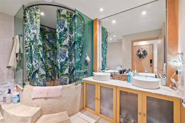101 Palm Harbor Pkwy Unit A303, Palm Coast, FL 32137 - bathroom with a bathtub, double vanity, tile patterned flooring, a shower, and recessed lighting