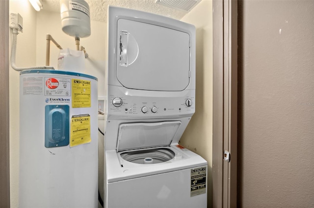101 Palm Harbor Pkwy Unit A303, Palm Coast, FL 32137 - laundry room with stacked washer / drying machine, water heater, and a textured wall