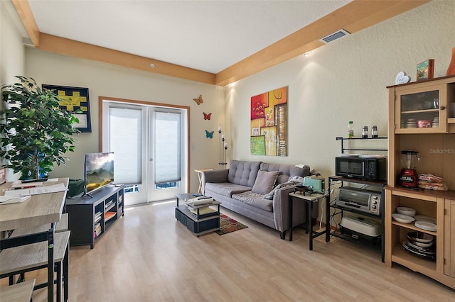 101 Palm Harbor Pkwy Unit A303, Palm Coast, FL 32137 - living area with light wood-style floors and french doors
