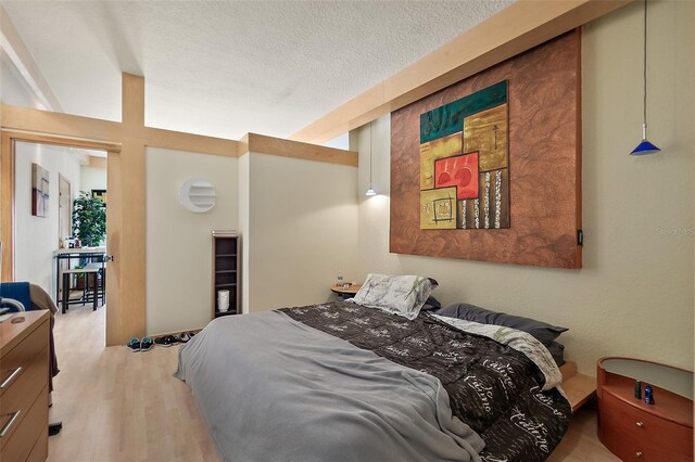 101 Palm Harbor Pkwy Unit A303, Palm Coast, FL 32137 - bedroom featuring wood finished floors and a textured ceiling