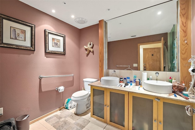 101 Palm Harbor Pkwy Unit A303, Palm Coast, FL 32137 - full bathroom featuring double vanity, toilet, tile patterned floors, baseboards, and recessed lighting