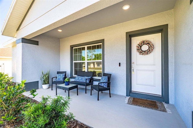 doorway to property with an outdoor hangout area and stucco siding