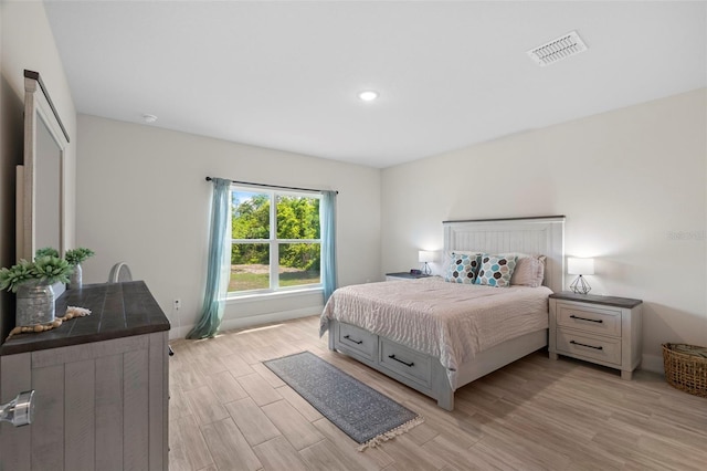 bedroom featuring recessed lighting, baseboards, visible vents, and light wood-type flooring