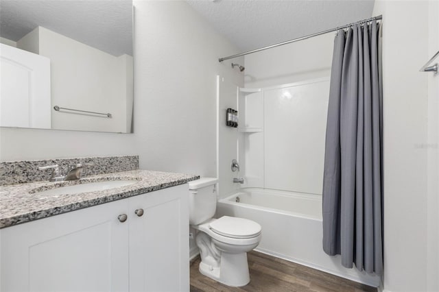 full bathroom featuring vanity, toilet, a textured ceiling, shower / bathtub combination with curtain, and wood finished floors