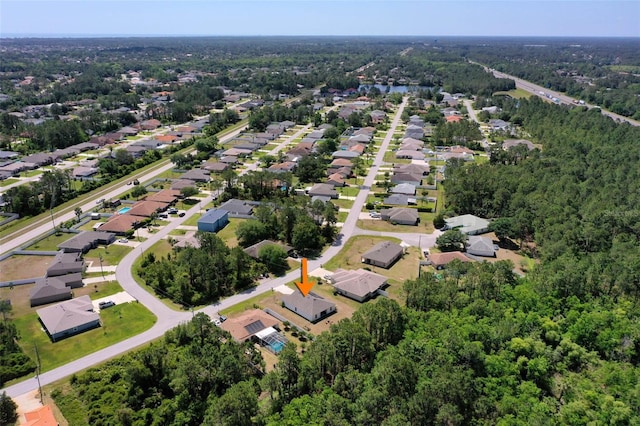 birds eye view of property featuring a residential view and a forest view