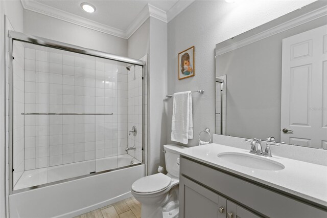 106 Key Grass Ct, Saint Johns, FL 32259 - bathroom featuring wood finished floors, vanity, toilet, shower / bath combination with glass door, and ornamental molding