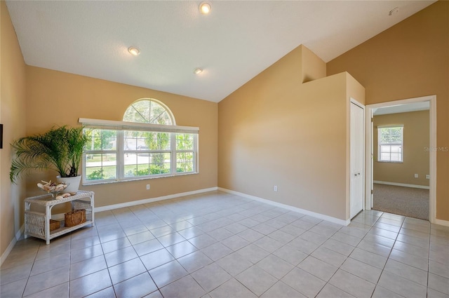 unfurnished room with baseboards, recessed lighting, light tile patterned floors, and high vaulted ceiling