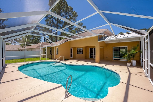 view of pool with glass enclosure, fence, a fenced in pool, and a patio area