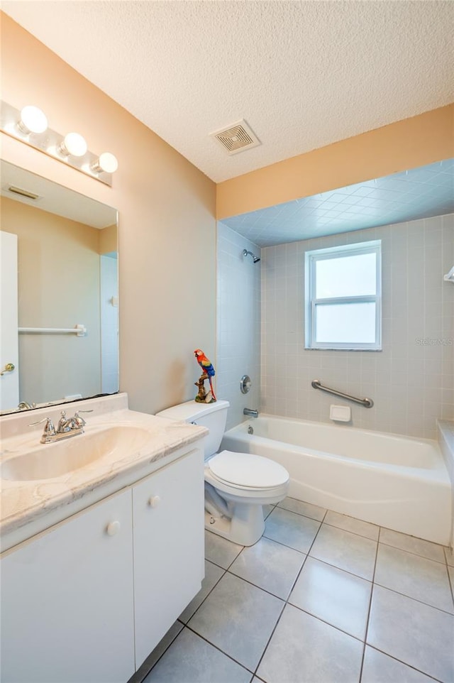full bathroom with visible vents, vanity, toilet, tile patterned floors, and  shower combination