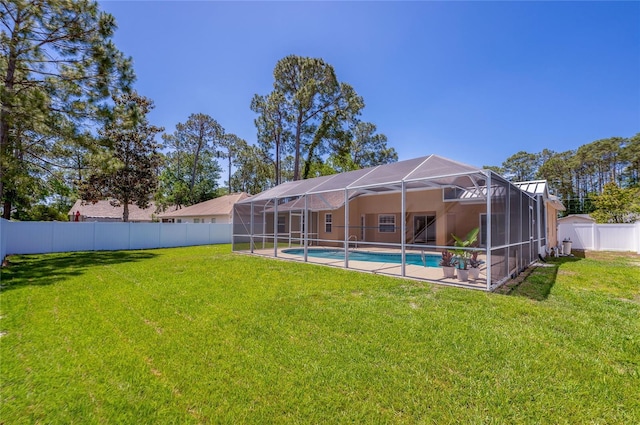 exterior space featuring a fenced in pool, a fenced backyard, a lanai, and a yard