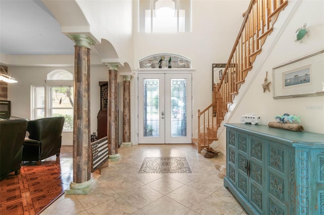 114 Emerald Lake Dr, Palm Coast, FL 32137 - foyer entrance featuring decorative columns, stairs, baseboards, french doors, and arched walkways