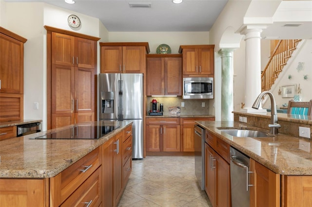 114 Emerald Lake Dr, Palm Coast, FL 32137 - kitchen with a kitchen island with sink, stainless steel appliances, decorative columns, and a sink
