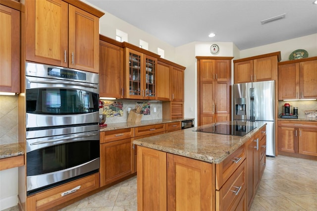 114 Emerald Lake Dr, Palm Coast, FL 32137 - kitchen featuring visible vents, brown cabinetry, decorative backsplash, and stainless steel appliances