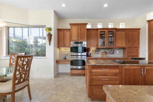 114 Emerald Lake Dr, Palm Coast, FL 32137 - kitchen featuring brown cabinets, decorative backsplash, and stainless steel double oven