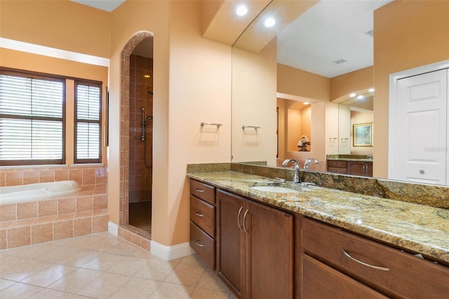 114 Emerald Lake Dr, Palm Coast, FL 32137 - bathroom featuring a bath, tile patterned flooring, vanity, recessed lighting, and tiled shower