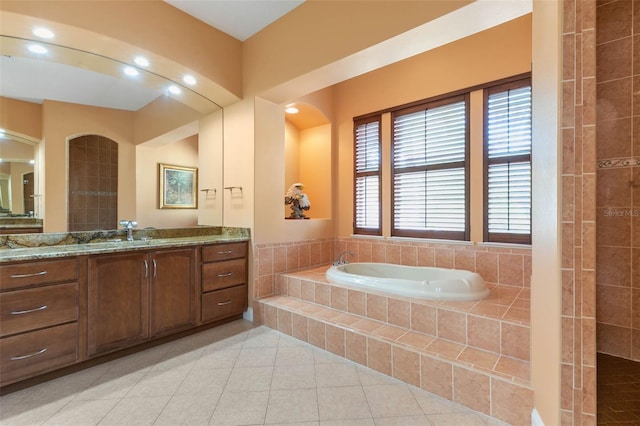 114 Emerald Lake Dr, Palm Coast, FL 32137 - bathroom with tile patterned floors, a garden tub, and vanity