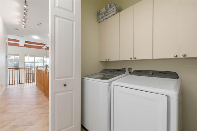 114 Emerald Lake Dr, Palm Coast, FL 32137 - laundry area featuring visible vents, washing machine and clothes dryer, cabinet space, light tile patterned floors, and track lighting