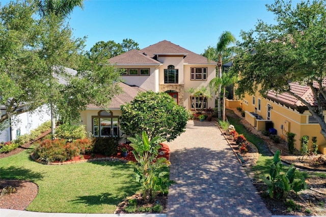 114 Emerald Lake Dr, Palm Coast, FL 32137 - mediterranean / spanish house featuring a front lawn and stucco siding