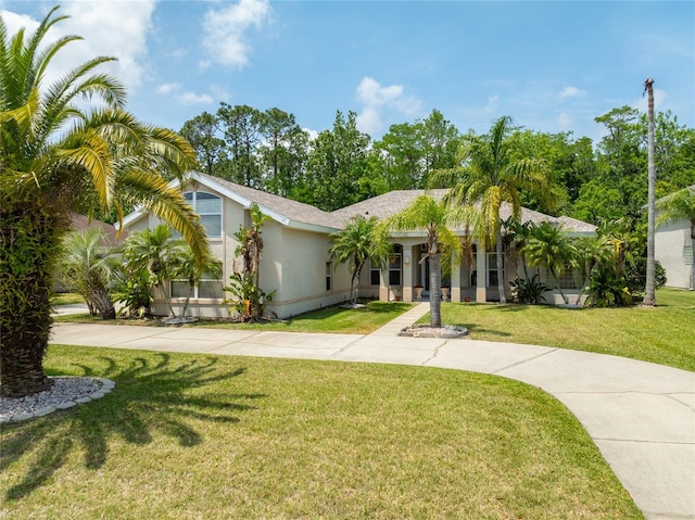 69 Coquina Ridge Way, Ormond Beach, FL 32174 - view of front of house with a front lawn, stucco siding, and driveway