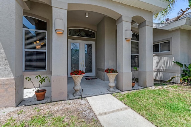 69 Coquina Ridge Way, Ormond Beach, FL 32174 - entrance to property with french doors and stucco siding