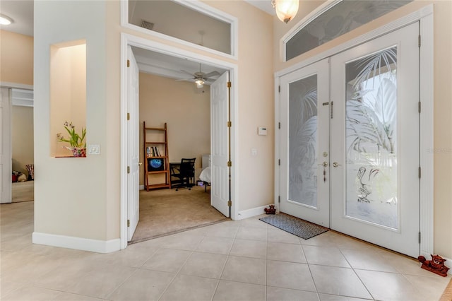 69 Coquina Ridge Way, Ormond Beach, FL 32174 - entryway with light colored carpet, french doors, baseboards, light tile patterned floors, and visible vents