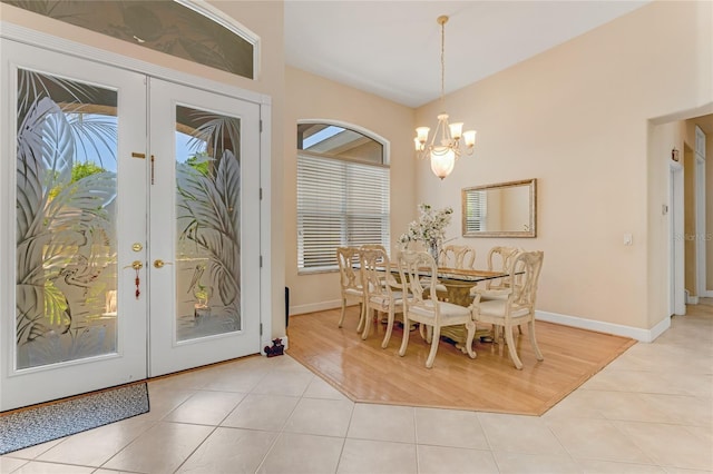 69 Coquina Ridge Way, Ormond Beach, FL 32174 - dining room with french doors, light tile patterned flooring, and a chandelier