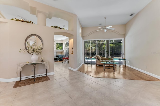 69 Coquina Ridge Way, Ormond Beach, FL 32174 - interior space with light tile patterned flooring, arched walkways, a ceiling fan, baseboards, and visible vents