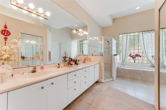 69 Coquina Ridge Way, Ormond Beach, FL 32174 - bathroom featuring a sink, double vanity, tile patterned floors, a shower stall, and a garden tub