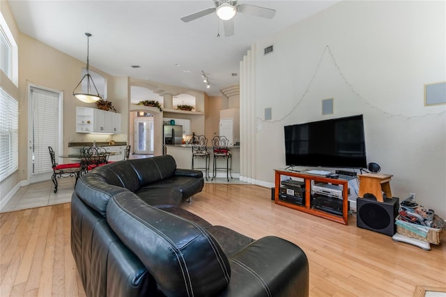 69 Coquina Ridge Way, Ormond Beach, FL 32174 - living area with a ceiling fan, baseboards, visible vents, and light wood-type flooring