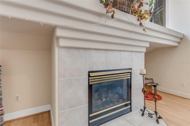 69 Coquina Ridge Way, Ormond Beach, FL 32174 - room details with baseboards, wood finished floors, and a tile fireplace