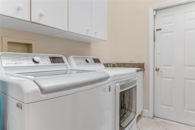 69 Coquina Ridge Way, Ormond Beach, FL 32174 - washroom with light tile patterned flooring, cabinet space, and washing machine and clothes dryer