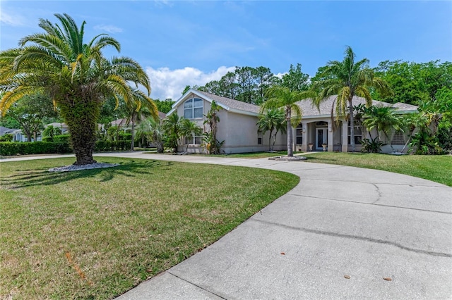 69 Coquina Ridge Way, Ormond Beach, FL 32174 - view of front of property featuring curved driveway, stucco siding, and a front yard