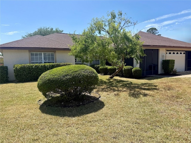 28 Weller Ln, Palm Coast, FL 32164 - view of front of home featuring an attached garage, a front lawn, roof with shingles, and stucco siding