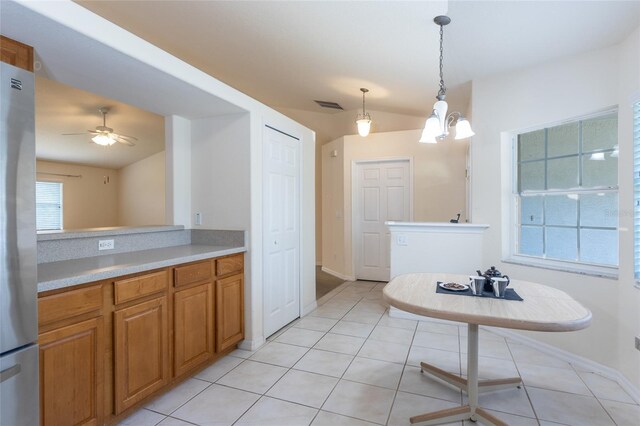 28 Weller Ln, Palm Coast, FL 32164 - interior space featuring visible vents, baseboards, tile patterned floors, ceiling fan with notable chandelier, and vaulted ceiling